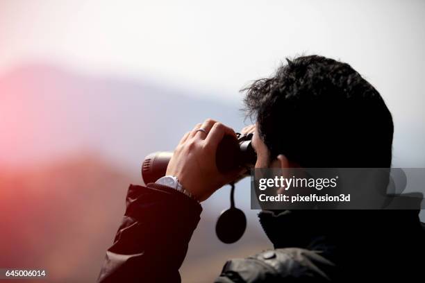 men looking through binoculars - binocular with man stock pictures, royalty-free photos & images