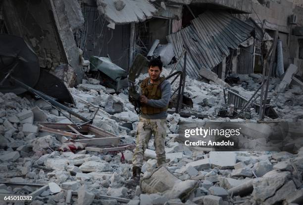 Member of Free Syrian Army uses a mine detector in the Syrian town of Al Bab after the town center has been entirely freed from Daesh terrorists as...