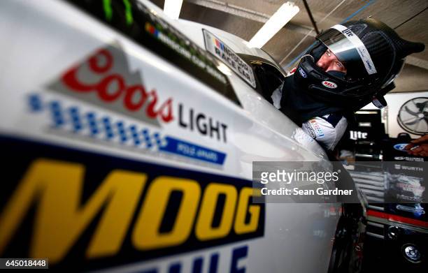 Brad Keselowski, driver of the Miller Lite Ford, gets into his car during practice for the 59th Annual DAYTONA 500 at Daytona International Speedway...