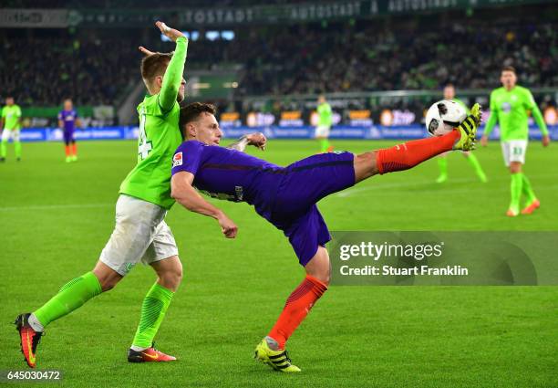 Robert Bauer of Bremen is challenged by Jakub Blaszczykowski of Wolfsburg during the Bundesliga match between VfL Wolfsburg and Werder Bremen at...