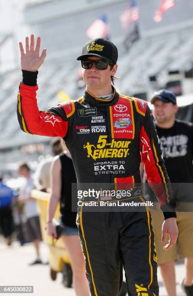 Erik Jones, driver of the 5-hour Energy Extra Strength Toyota, walks through the garage area during practice for the 59th Annual DAYTONA 500 at...
