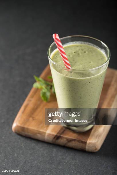 glass of green smoothie. - avocado smoothie stock-fotos und bilder