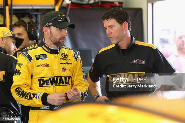 Matt Kenseth, driver of the DeWalt Toyota, talks with his crew chief Jason Ratcliff in the garage area during practice for the 59th Annual DAYTONA...