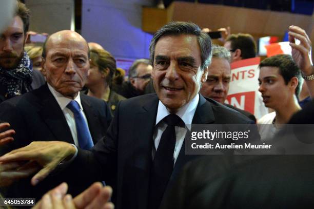 French candidate for the right-wing 'Les Republicains' Party Francois Fillon salutes the crowd as he arrives on stage for a political meeting on...