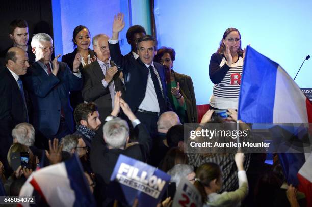 French candidate for the right-wing 'Les Republicains' Party Francois Fillon salutes the crowd as he arrives on stage for a political meeting on...