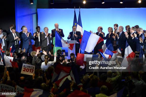 French candidate for the right-wing 'Les Republicains' Party Francois Fillon salutes the crowd as he arrives on stage for a political meeting on...