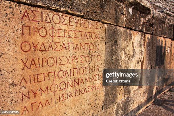 griechische schrift in hierapolis amphitheater - ancient greek alphabet stock-fotos und bilder