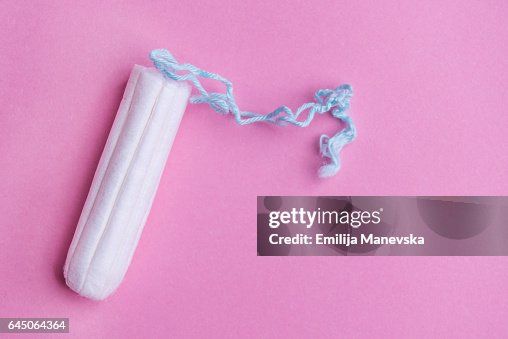 Clean tampon on pink background Clean tampon on pink background
