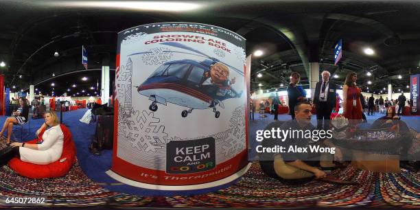 Members of Media DC chat at their booth as conference attendees look on during the Conservative Political Action Conference at the Gaylord National...