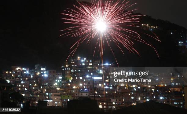 Fireworks are launched above the Pavao-Pavaozinho 'favela' community on the first official day of Carnival on February 24, 2017 in Rio de Janeiro,...