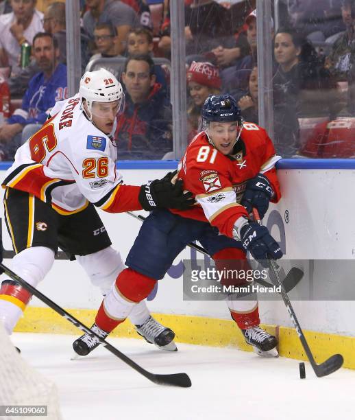 The Florida Panthers' Jonathan Marchessault fights for the puck against the Calgary Flames defenseman Michael Stone during the second period at BB&T...