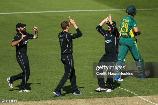 To R, Dean Brownlie, Lockie Ferguson and Neil Broom of New Zealand celebrate the wicket of Dwaine Pretorius of South Africa during game three of the...