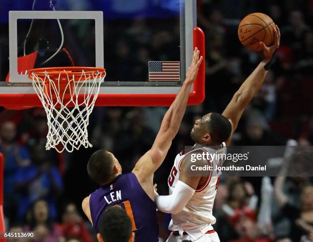 Dwyane Wade of the Chicago Bulls goes up for a dunk over Alex Len of the Phoenix Suns at the United Center on February 24, 2017 in Chicago, Illinois....