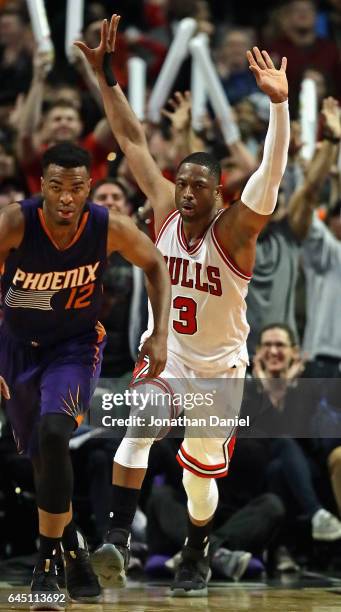 Dwyane Wade of the Chicago Bulls celebrates after dunking over Alex Len of the Phoenix Suns at the United Center on February 24, 2017 in Chicago,...