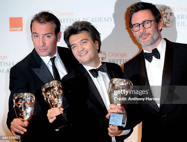 Actor Jean Dujardin , producer Thomas Langmann and director Michel Hazanavicius pose in the press room with the Best Film awards during 2012 Orange...