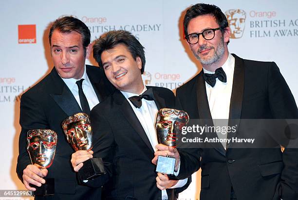 Actor Jean Dujardin , producer Thomas Langmann and director Michel Hazanavicius pose in the press room with the Best Film awards during 2012 Orange...