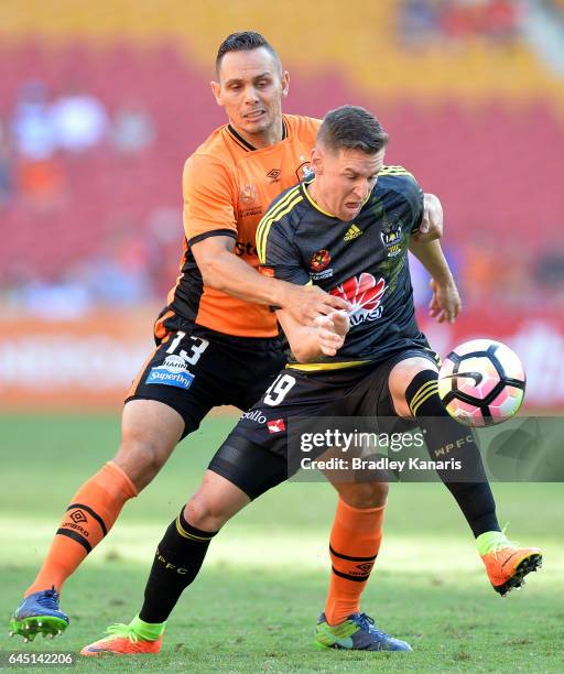 Shane Smeltz of the Phoenix is pressured by the defence of Jade North of the Roar during the round 21 A-League match between the Brisbane Roar and...