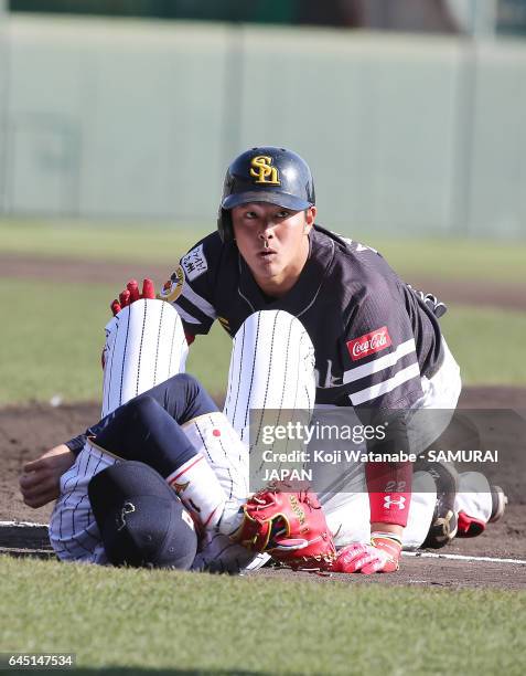Ayatsugu Yamashita of Fukuoka SoftBank Hawks looks up after crashing with Seiichi Uchikawa of Samurai Japan in the eighth inning during the SAMURAI...