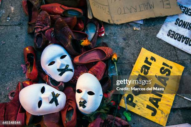 Masks, shoes and placards on the floor during a protest against gender violence.