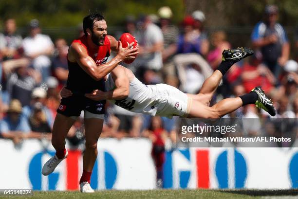 Jordan Lewis of the Demons is tackled by Sam Docherty of the Blues during the AFL 2017 JLT Community Series match between the Melbourne Demons and...