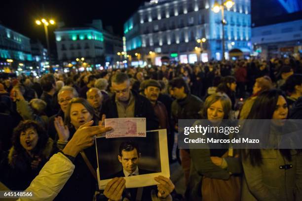 Woman holds a picture of Urdangarin during a protest against corruption case "Noos".