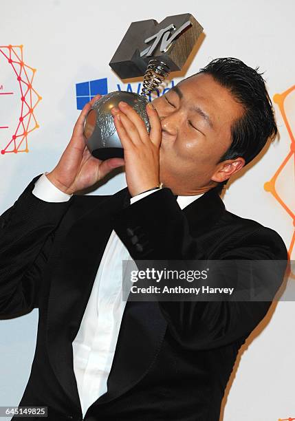 Singer Psy poses backstage with his award for Best Video in the photo room at the MTV EMA's 2012 at Festhalle Frankfurt on November 11, 2012 in...