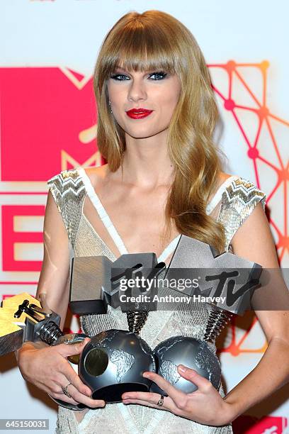 Singer Taylor Swift poses backstage in the photo room with her awards for Best Female, Best Live and Best Look at the MTV EMA's 2012 at Festhalle...