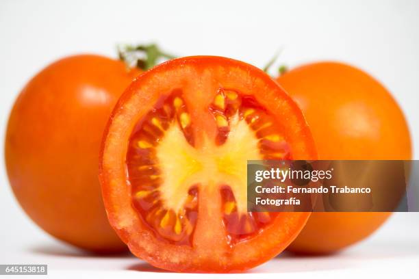 tomato split in half with seeds - tomato seeds stock pictures, royalty-free photos & images