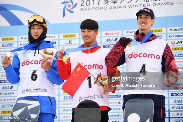 Lee-jun Kweon of South Korea , Yiwei Zhang of China and Ayumu Nedefuji of Japan pose on the podium during the medal ceremony for the Snowboarding...