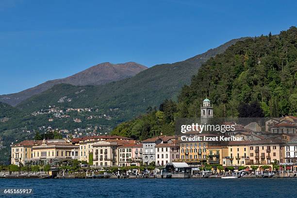 bellagio village distant view from lake como - tourist resort stock illustrations