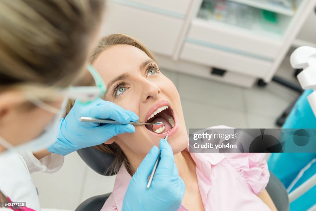 Blond young woman having dental exam