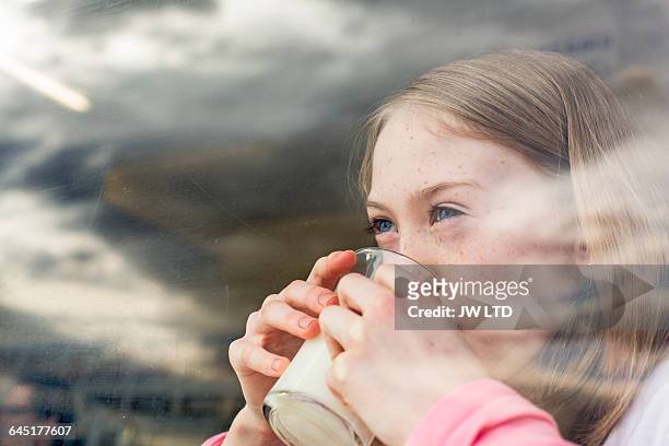 girl (8-9) drinking milk - dairy product stock-fotos und bilder