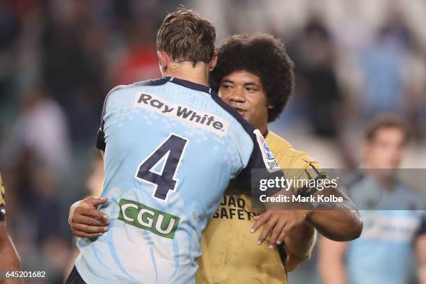 Dean Mumm of the Waratahs and Tatafu Polota-Nau of the Force embrace after the round one Super Rugby match between the Waratahs and the Force at...