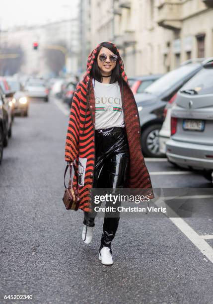Yuwei Zhangzou wearing white Gucci shirt, striped hooded coat, vinyl pants outside Etro during Milan Fashion Week Fall/Winter 2017/18 on February 24,...