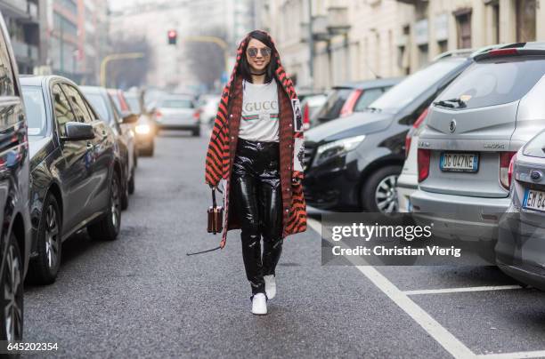 Yuwei Zhangzou wearing white Gucci shirt, striped hooded coat, vinyl pants outside Etro during Milan Fashion Week Fall/Winter 2017/18 on February 24,...