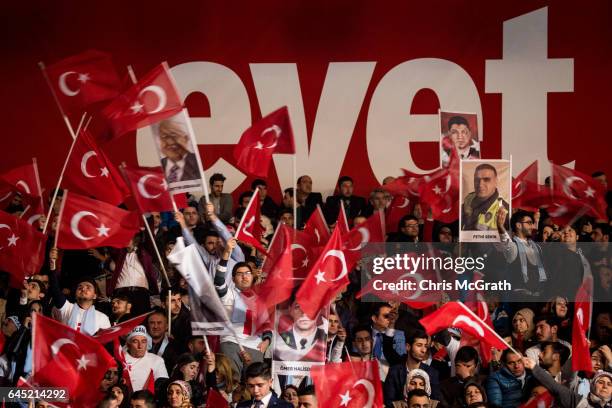 People wave national flags and "Yes" banners during a rally officially opening the AKP Party "Yes" constitutional referendum campaign held at the...