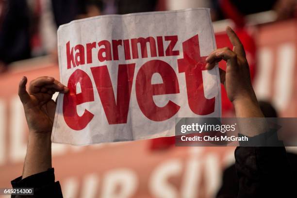 Man holds a "Yes" banner during a rally officially opening the AKP Party "Yes" constitutional referendum campaign held at the Ankara Arena on...