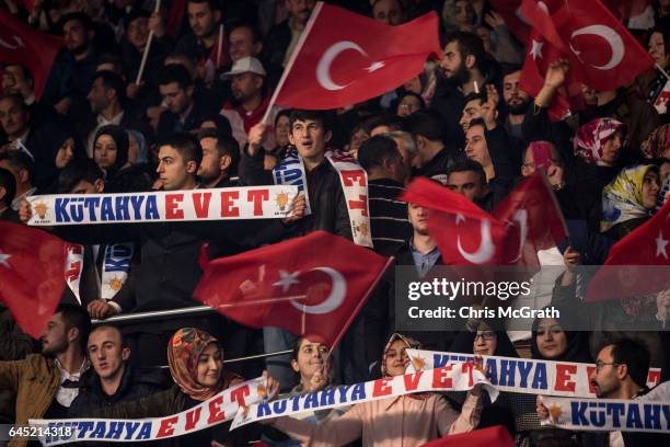 People wave national flags and "Yes" banners during a rally officially opening the AKP Party "Yes" constitutional referendum campaign held at the...