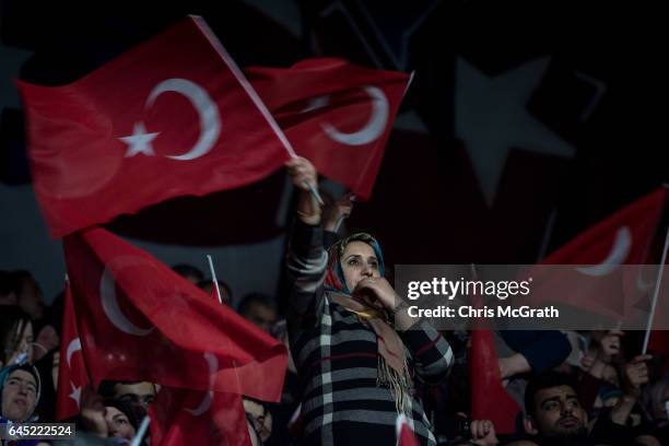 Woman waves a national flag during a rally officially opening the AKP Party "Yes" constitutional referendum campaign held at the Ankara Arena on...