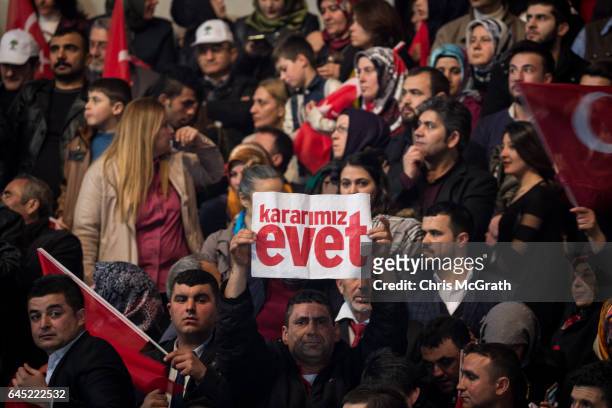 Man holds a "Yes" banner during a rally officially opening the AKP Party "Yes" constitutional referendum campaign held at the Ankara Arena on...