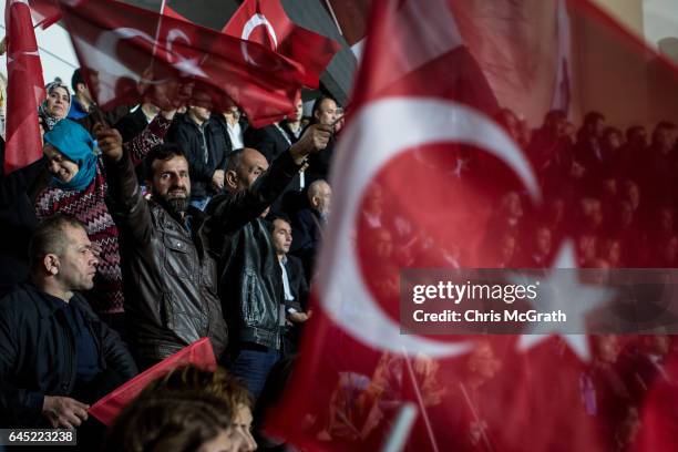 Man waves a national flag during a rally officially opening the AKP Party "Yes" constitutional referendum campaign held at the Ankara Arena on...