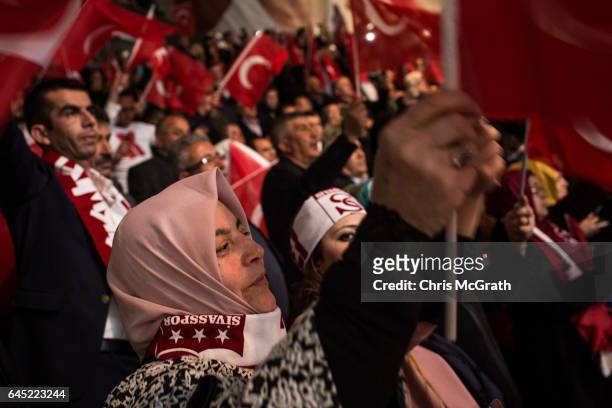 Woman waves a national flag during a rally officially opening the AKP Party "Yes" constitutional referendum campaign held at the Ankara Arena on...