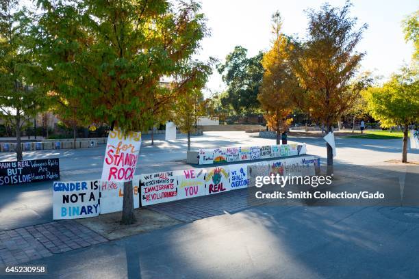 Handwritten protest posters for various causes including Black Live Matter, LGBT rights, Standing Rock and womens' rights on a quad at Stanford...