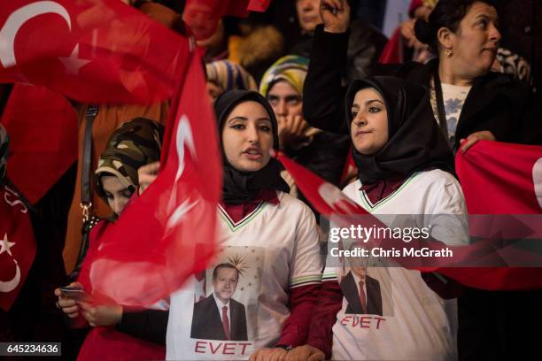 Women wave national flags at a rally officially opening the AKP Party "Yes" constitutional referendum campaign held at the Ankara Arena on February...