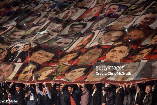 People unfurl a large banner showing the faces of people killed during the July 15 failed coup at a rally officially opening the AKP Party "Yes"...