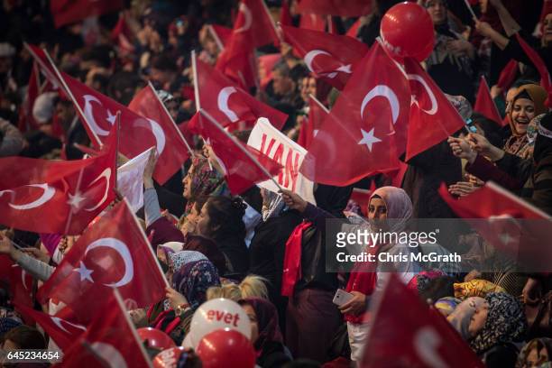 People wave national flags at a rally officially opening the AKP Party "Yes" constitutional referendum campaign held at the Ankara Arena on February...