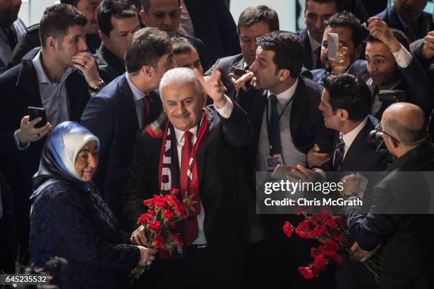 Turkey's Prime Minister Binali Yildirim, throws a rose to the crowd as he arrives at a rally officially opening the AKP Party "Yes" constitutional...