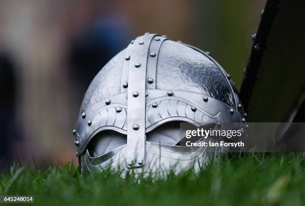 Viking helmet lies on the grass as re-enactors from Canute's Army prepare march to Coppergate in a show of strength before battle during a living...