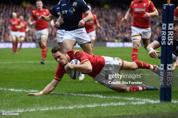 Liam Williams of Wales dives past Stuart Hogg of Scotland to score the opening try during the RBS Six Nations match between Scotland and Wales at...