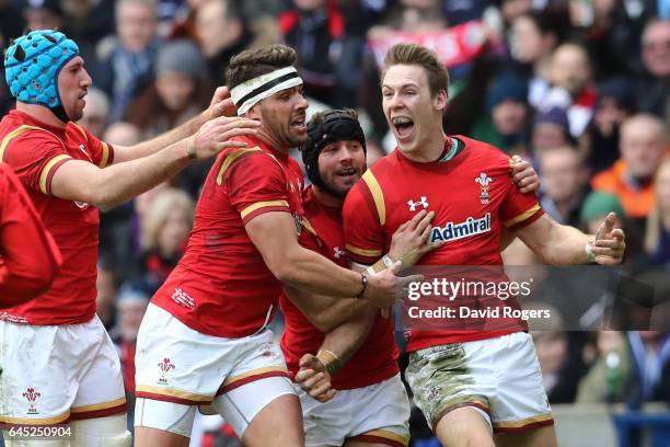 Liam Williams of Wales celebrates with teammates Leigh Halfpenny, Rhys Webb and Justin Tipuric after scoring the opening try during the RBS Six...